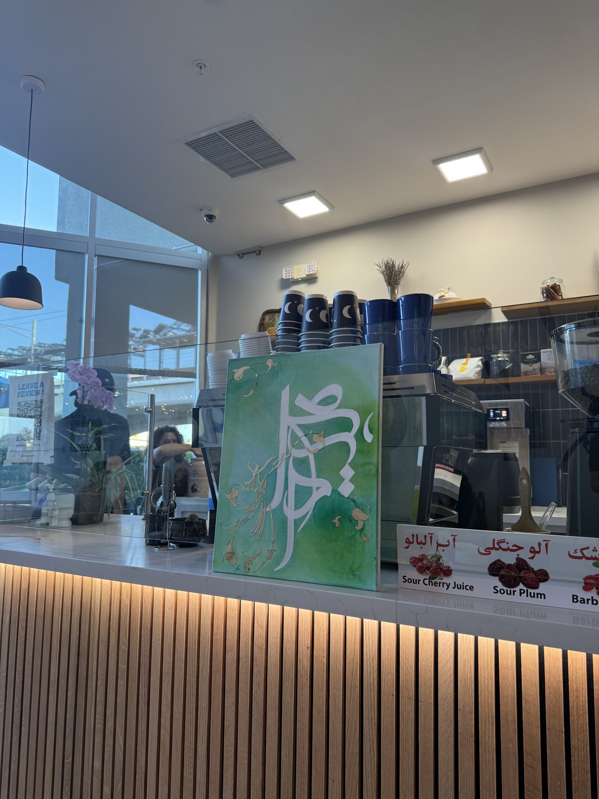 A green calligraphy canvas on display at the Los Angeles event